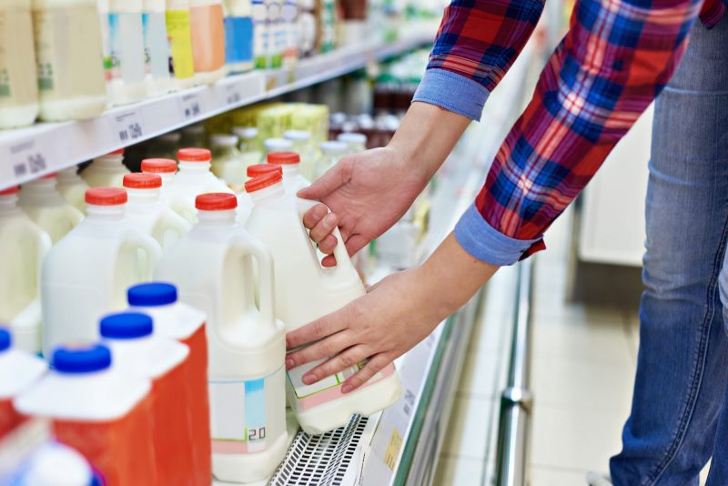 Woman shopping milk in store