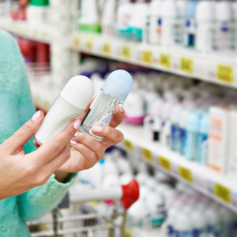 Woman in shop chooses deodorant