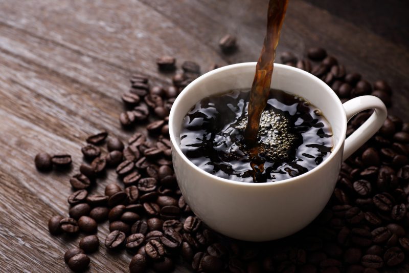 Hot coffee on wooden table